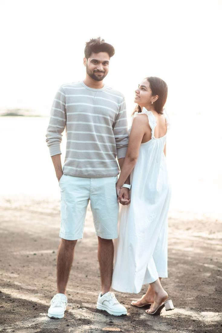 Couple walking hand in hand along an empty beach