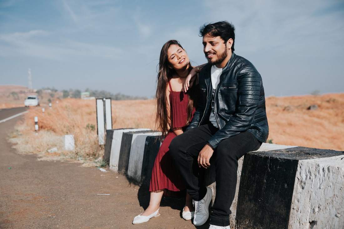 Couple laughing on a bench