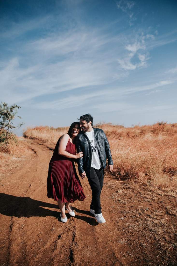 Couple walking a dry grassland path