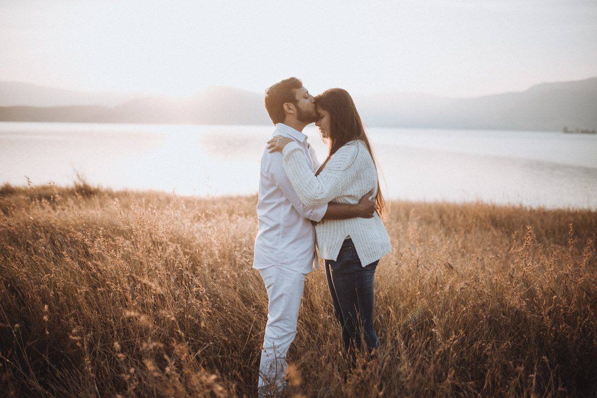 Couple walking through golden grassland