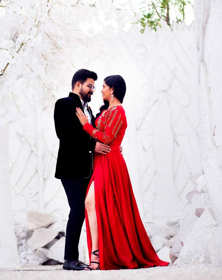 Couple embracing amid a striking white rock formation