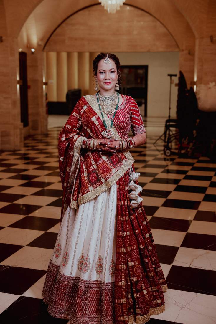 Bride standing in a black and white marble hall