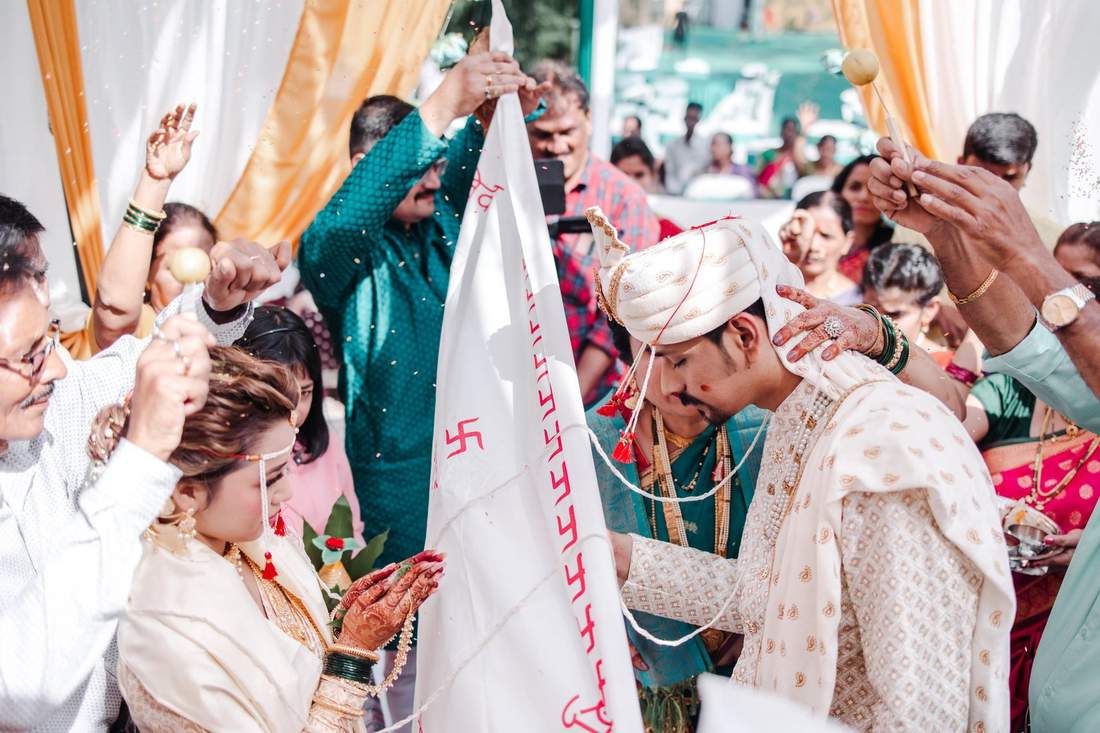 Wedding dhwaja ceremony with crowd celebrating
