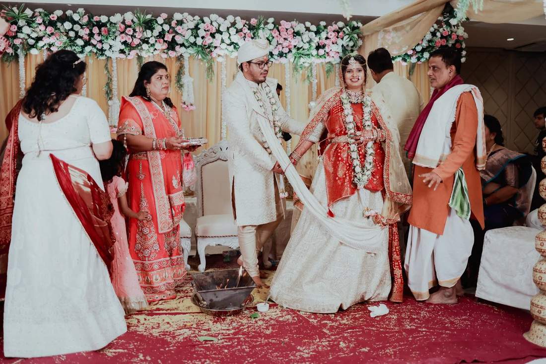 Couple taking phera rounds at the wedding mandap