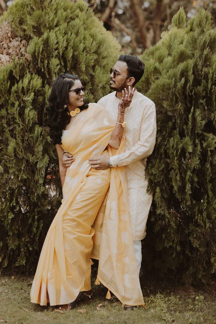 Couple smiling at each other during mehendi celebrations