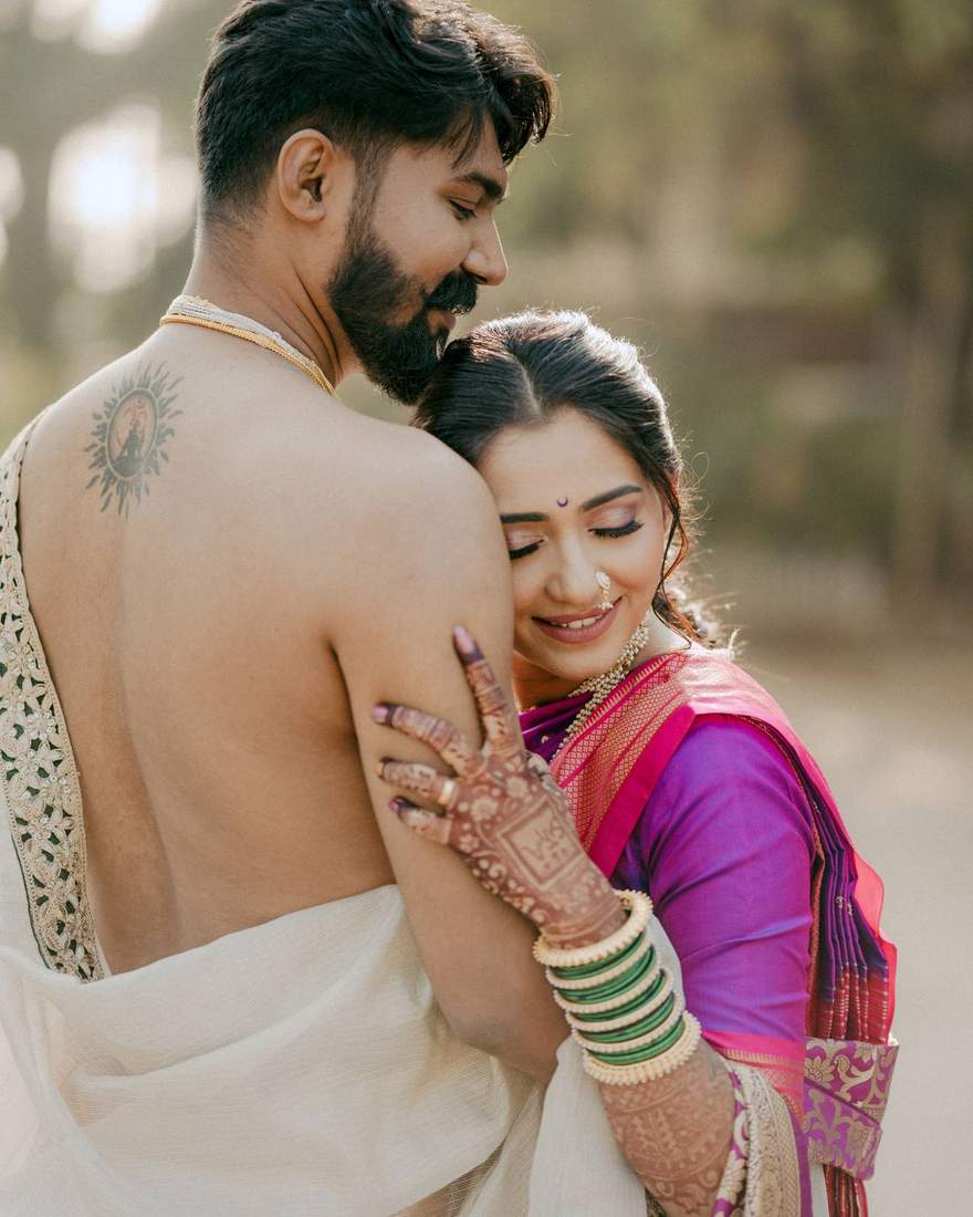 Groom embracing bride in a close outdoor portrait