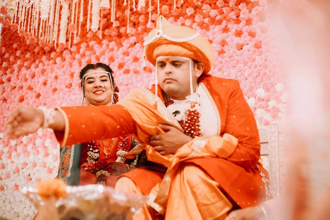 Couple exchanging garlands at their wedding