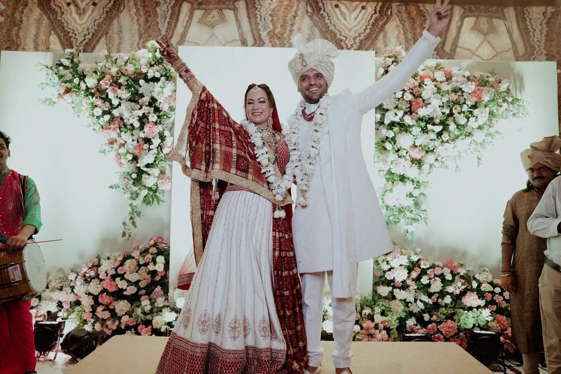 Bride and groom cheering on stage after their wedding