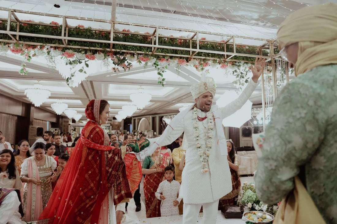 Bride and groom cheering during their garland walk