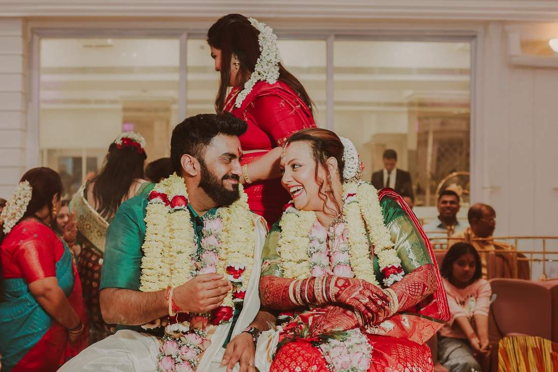Couple laughing together in traditional wedding attire