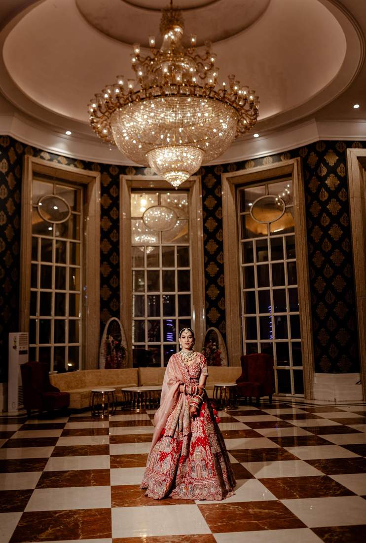 Bride standing under a grand chandelier