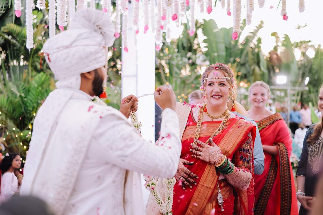 Groom placing a garland on the bride during the varmala ceremony