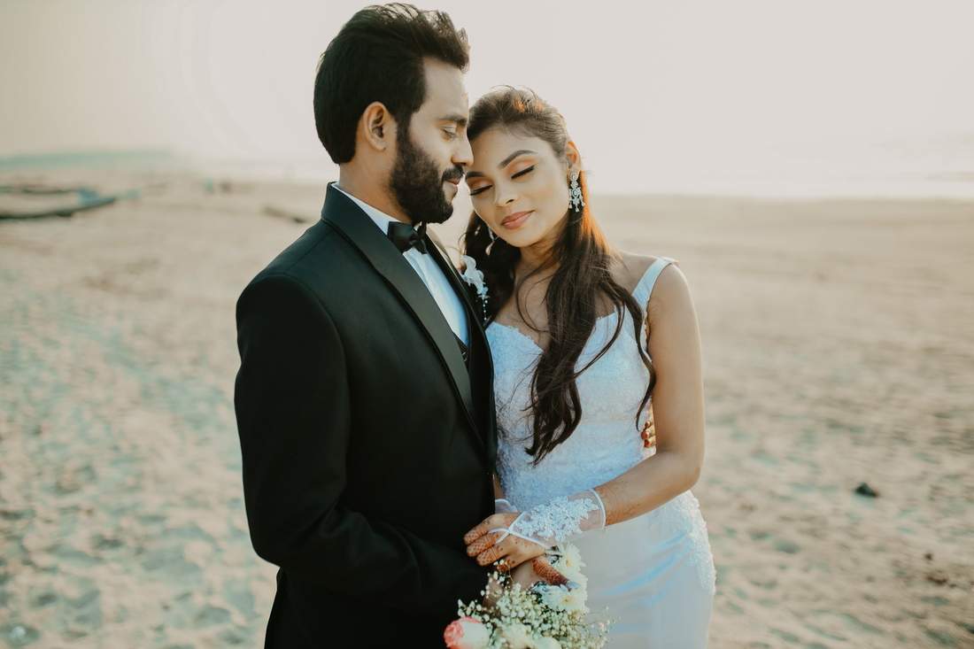 Couple portrait on a beach at golden hour